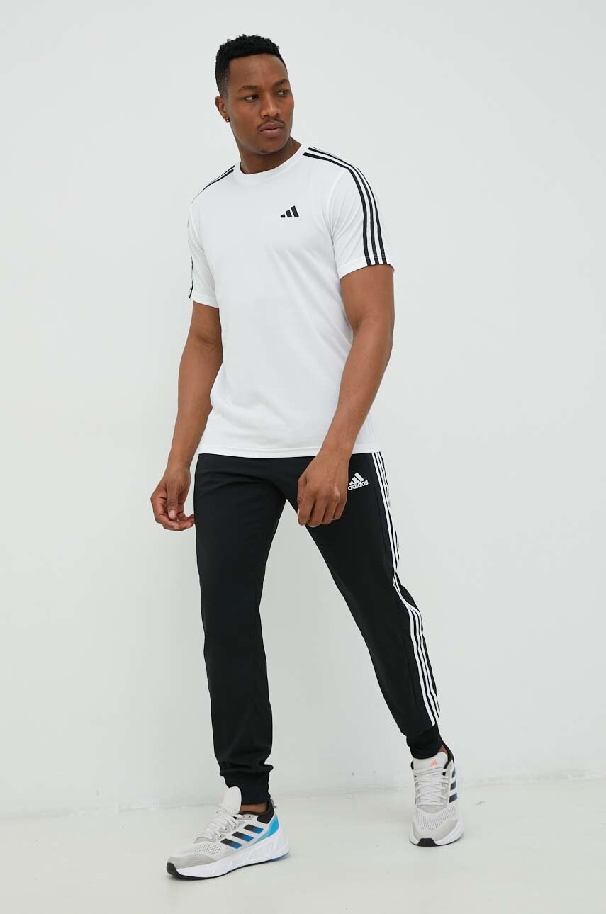 Штани для тренувань adidas чоловічі колір чорний з аплікацією