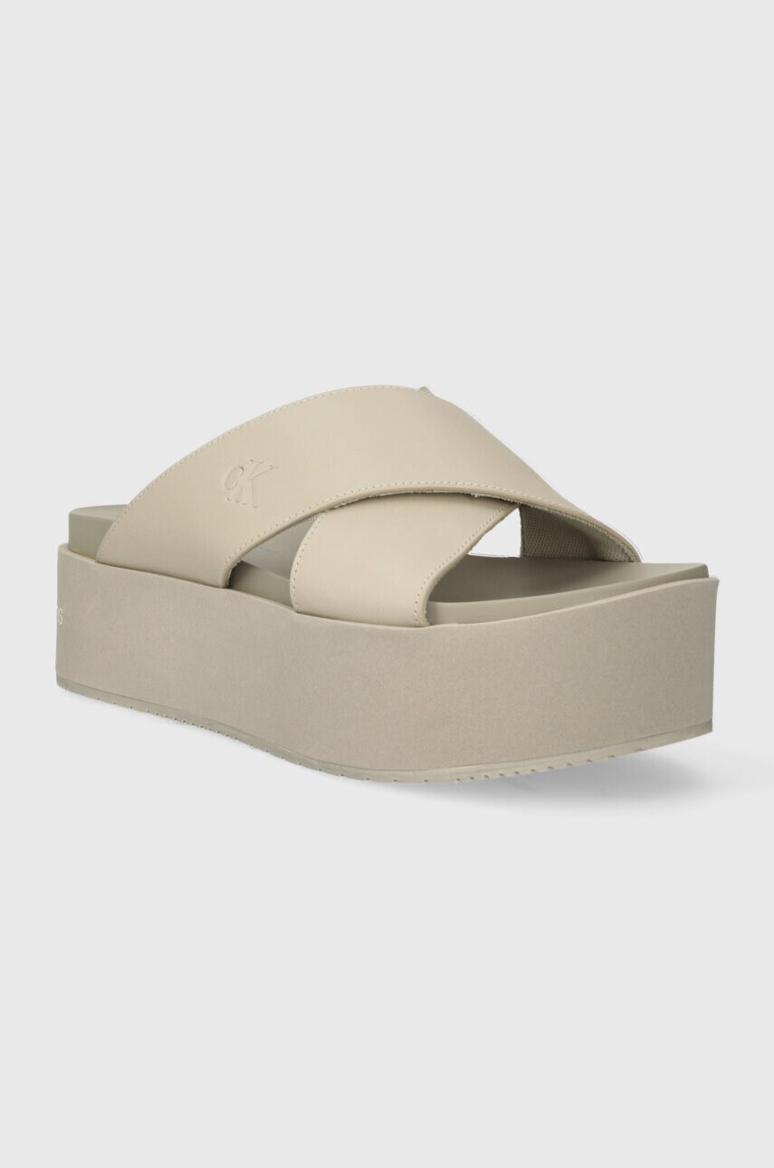Шкіряні шльопанці Calvin Klein Jeans FLATFORM CROSS MG UC жіночі колір бежевий на платформі