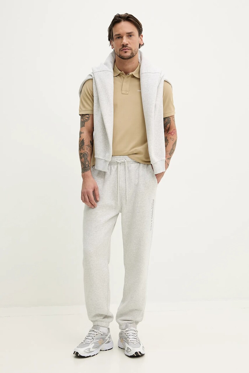 Бавовняне поло Tommy Jeans чоловіче колір бежевий однотонне DM0DM20914